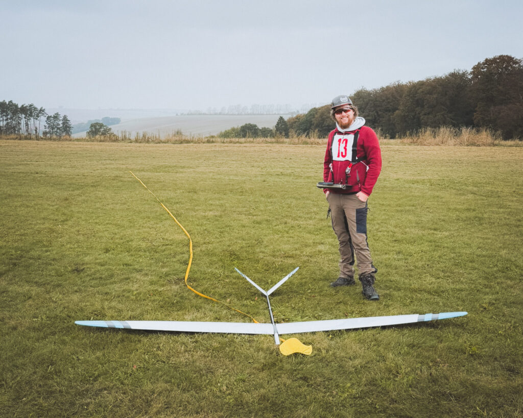 Competitor standing next to his F3B Glider after a successful landing