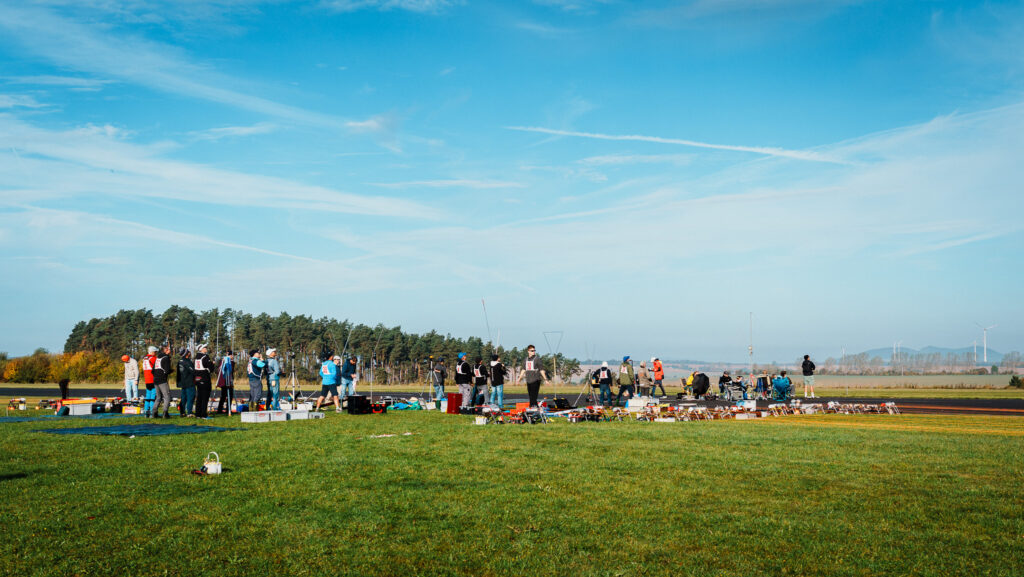 Showing the action of the competition. A lot of competitors on the airfield